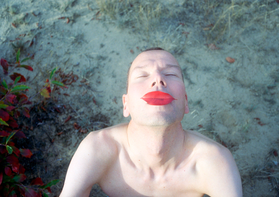 Portrait of man with leaves on mouth